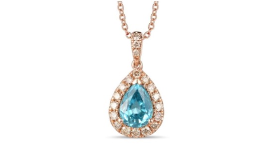 A rose gold pendant necklace with a light blue center stone surrounded by diamonds, available at Goldsmith Gallery Jewelers.