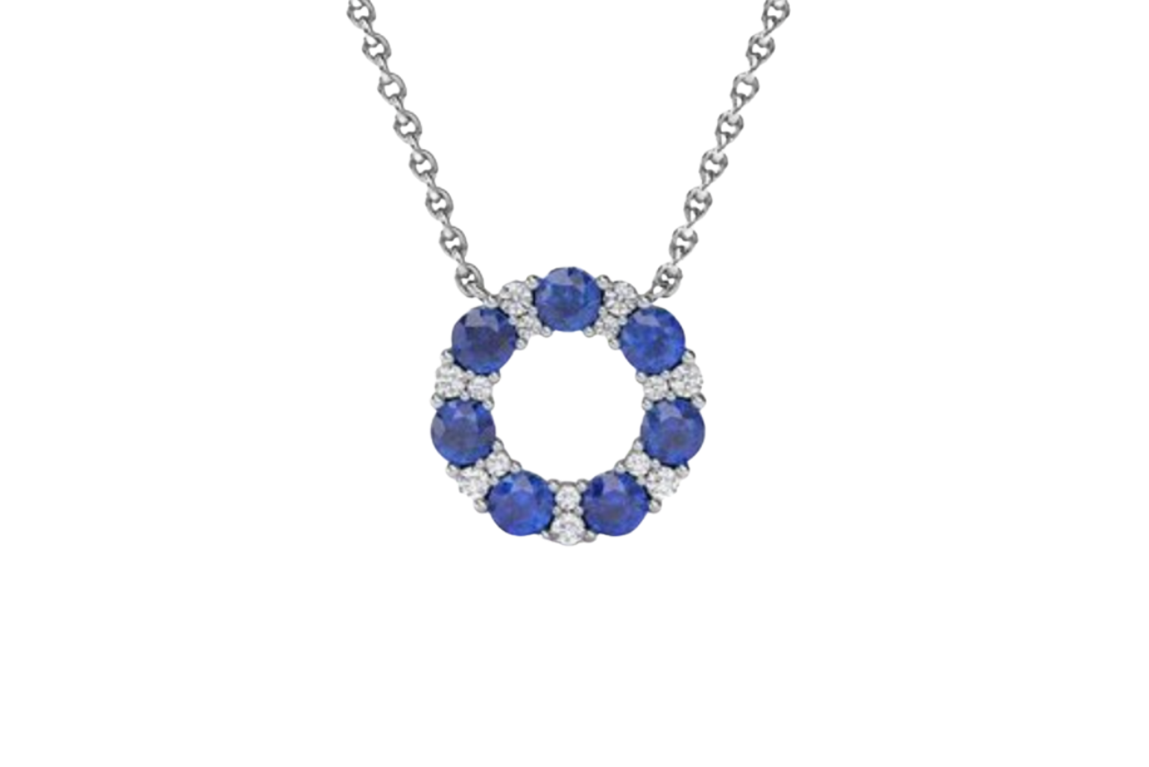 A sapphire and diamond necklace with a circle pendant.