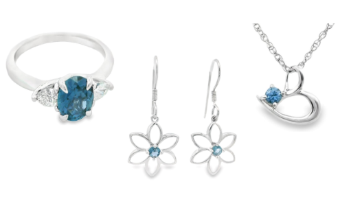 A fashion ring, a pair of earrings, and a pendant necklace featuring Yogo sapphires, all available at Goldsmith Gallery Jewelers.