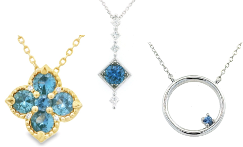A close-up of three different pendant necklaces featuring Yogo sapphires, all available at Goldsmith Gallery Jewelers.