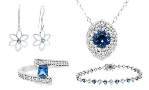 A selection of fine jewelry featuring Yogo sapphires— one necklace, a pair of earrings, a bracelet, and an engagement ring— all available at Goldsmith Gallery Jewelers.