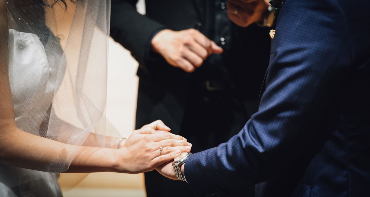 A bride and groom exchange vows at their wedding ceremony.